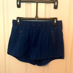 Athleta woman’s blue shorts. Flattering front zippers and lined pockets.